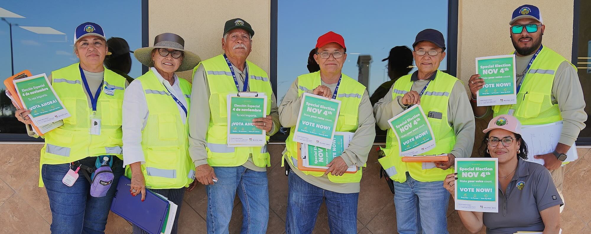 Community members holding informational flyers
